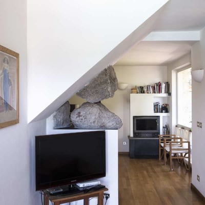 Stones from the hillside form part of the cottage