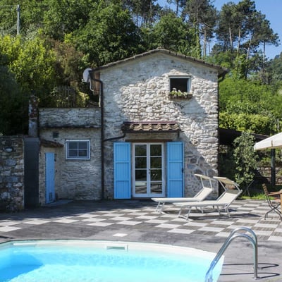 The pool is right in front of the house