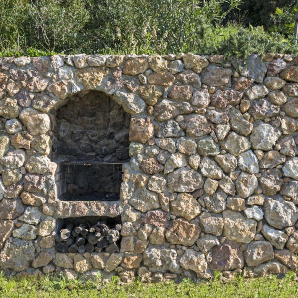 The barbecue is built into the dry stone wall