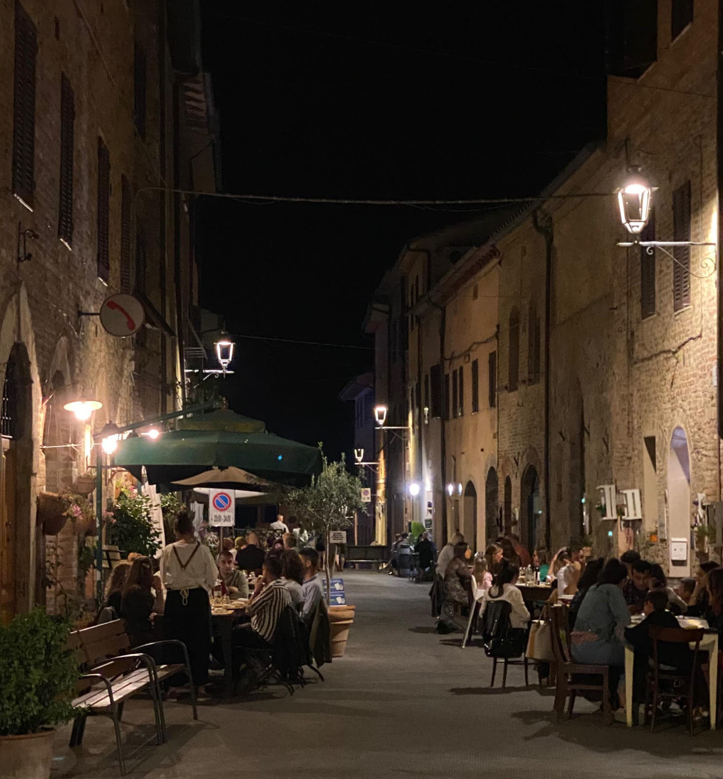 Casole's main street is alive at night with families enjoying the summer evenings. night-casole